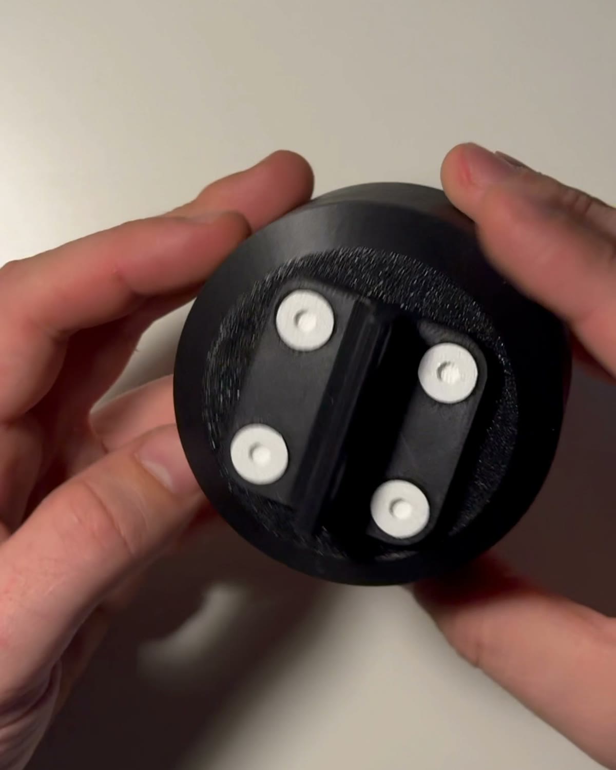 The printed box with the bracket bolted on, held in a hand